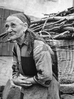 old-peasant-woman-carrying-load-of-sticks-400